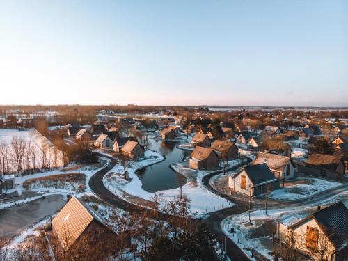 a small town in the snow with a river at Ridderstee Ouddorp Duin in Ouddorp