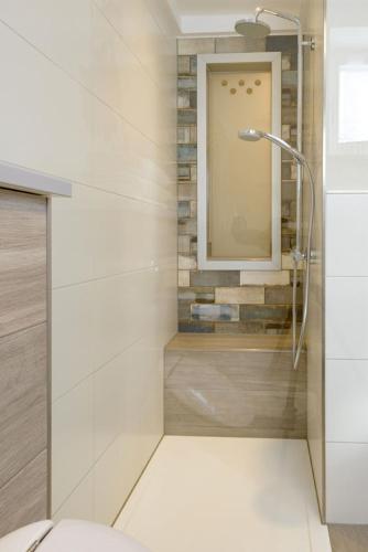 a bathroom with a shower and a mirror at Ferienwohnung Völkl in Böbrach