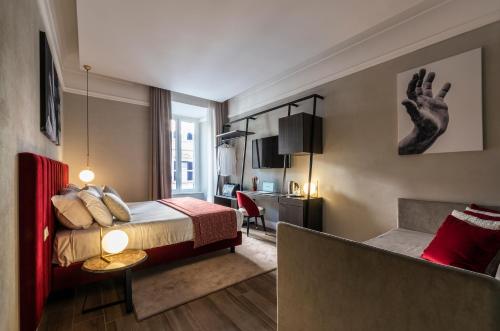 a bedroom with a bed and a living room at Growel Exclusive Suites San Pietro in Rome