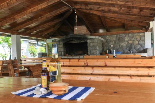 a table with a bottle of wine and a fireplace at Apartments Suzy in Vantačići