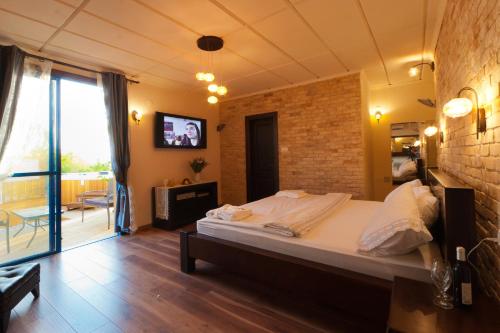 a bedroom with a large bed and a brick wall at shmulik's resort couples or families only in Had Nes