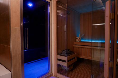 a walk in shower with a glass door at Maison Bertin in Etroubles
