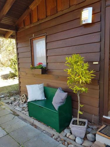 a green couch sitting in front of a building at Ferienhaus Bussard in Gammelsbach