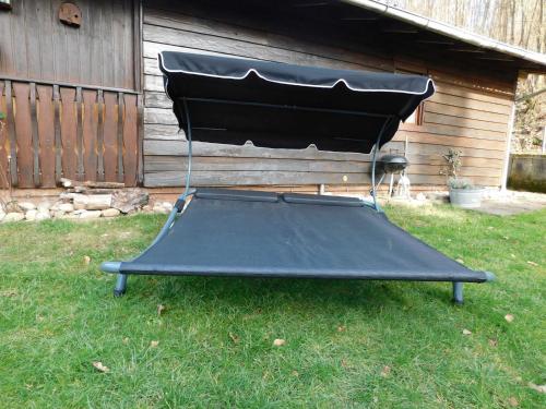 a black trampoline in the grass in a yard at Ferienhaus Bussard in Gammelsbach