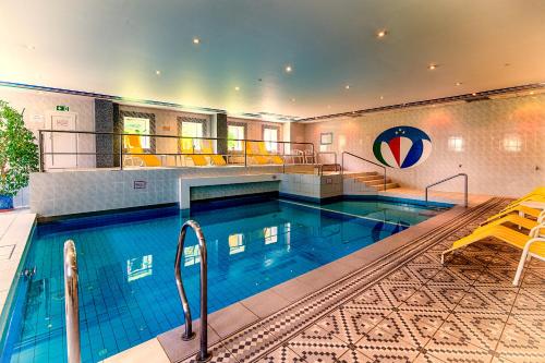 a large swimming pool in a building at Panorama Hotel Oberwiesenthal in Kurort Oberwiesenthal