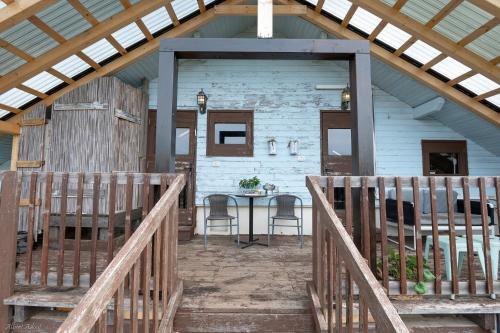 a porch of a house with a table and chairs at Healing Hands in Merom Golan