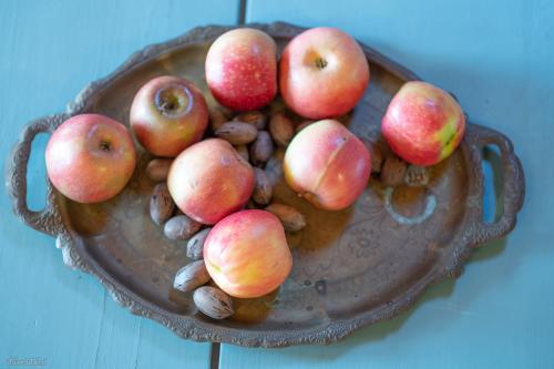 a bowl of apples and nuts on a table at Healing Hands in Merom Golan