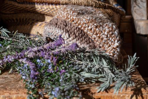 a bunch of purple flowers on a wooden table at Healing Hands in Merom Golan
