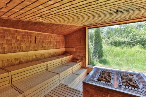 an empty sauna with a large window in it at ERMITAGE Wellness- & Spa-Hotel in Gstaad