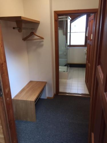 a hallway of a bathroom with a bench and a mirror at Naturata Hotel in Überlingen