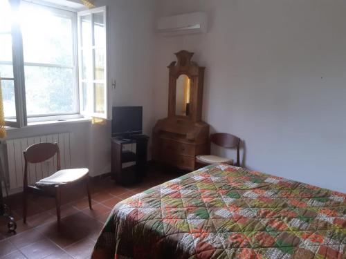 a bedroom with a bed and a tv and windows at la casa di Mario in Itri