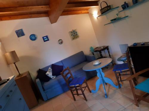 a living room with a blue couch and a table at la casa di Mario in Itri