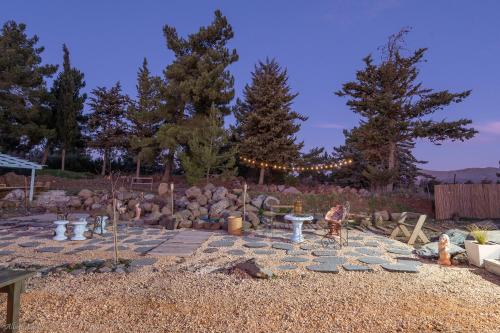 a fire pit in a yard with trees and lights at Ay La in El-Rom