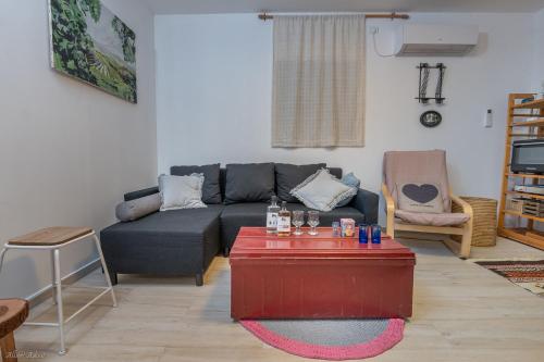a living room with a couch and a coffee table at Ay La in El-Rom