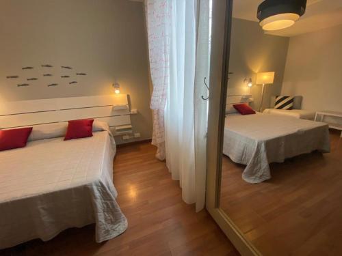 a bedroom with two beds and a mirror at Hotel Il colle di Monterosso in Monterosso al Mare