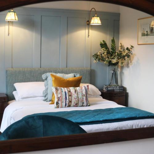 a bedroom with a large bed with pillows at Tower Hotel in Lincoln