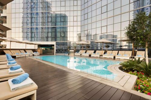 a large swimming pool in front of a large building at TRYP by Wyndham Dubai in Dubai