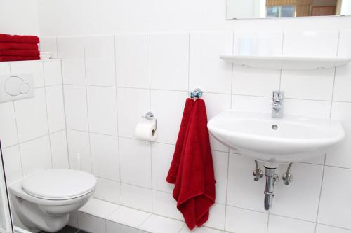 bagno bianco con servizi igienici e lavandino di Hotel Fürstenberg a Essen
