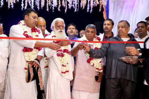 a group of men cutting a ribbon at a ceremony at DD Suites Hotel in Agra