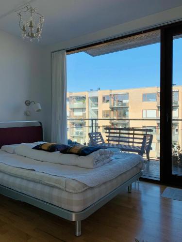 a bedroom with a bed and a large window at ApartmentInCopenhagen Apartment 651 in Copenhagen