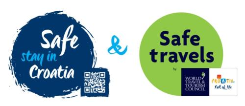 two signs that say safe travels and stay in canada and the safe travels logo at Krka Fairytale village in Rupe