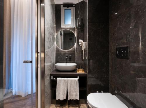 a bathroom with a sink and a mirror at Growel Exclusive Suites San Pietro in Rome