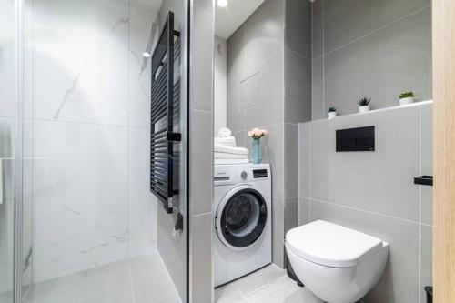 a bathroom with a washing machine and a toilet at Beautiful apartment in Vienna's heart 1D in Vienna