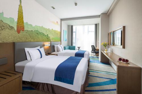 a hotel room with two beds and a window at Holiday Inn Express Hangzhou East Station by IHG in Hangzhou