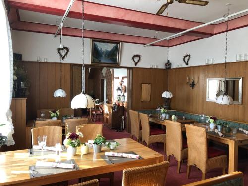 a dining room with wooden tables and chairs at Hotel-Restaurant Wilhelmsbad in Seesen