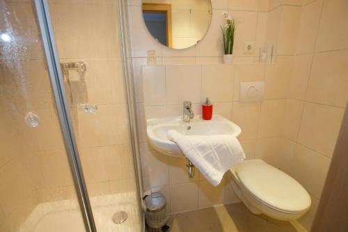 a bathroom with a toilet and a sink and a shower at Hotel-Restaurant Wilhelmsbad in Seesen