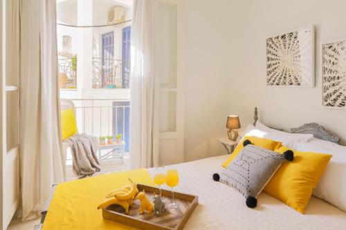 a bedroom with a bed with a tray with drinks on it at Casa Blue Sea View, Philian Collection in Skiathos Town
