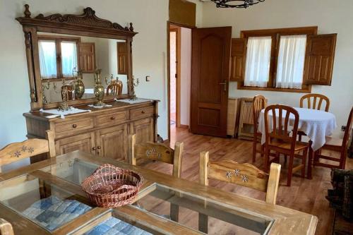 a kitchen with a table and a dining room at Casa Rural Serafïn, Pet Friendly in Renera