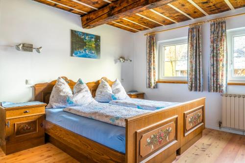 sypialnia z drewnianym łóżkiem z niebieską pościelą w obiekcie Ferienwohnung Schirla Stub´m w mieście Krispl