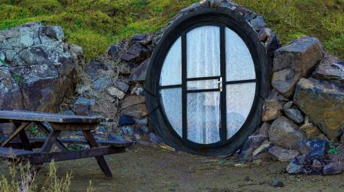 a window in a stone wall next to a bench at Sahil Kamp İstanbul Hotel in Sile
