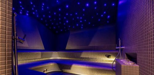 a bathroom with a tub with blue lights on the ceiling at SPA Nida in Nida