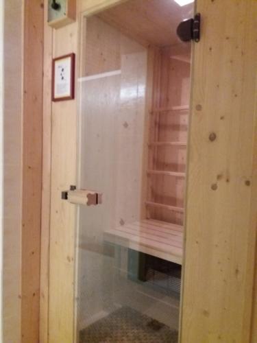 a door to a room with a bench in it at Parkhotel Ruhpolding inklusive Chiemgaukarte in Ruhpolding