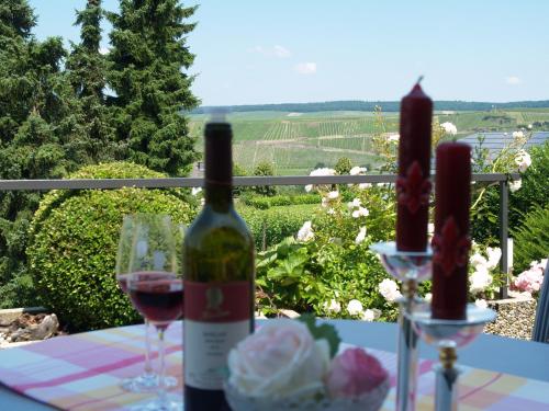 a bottle of wine and two glasses on a table at Weingut Bastian in Brauneberg