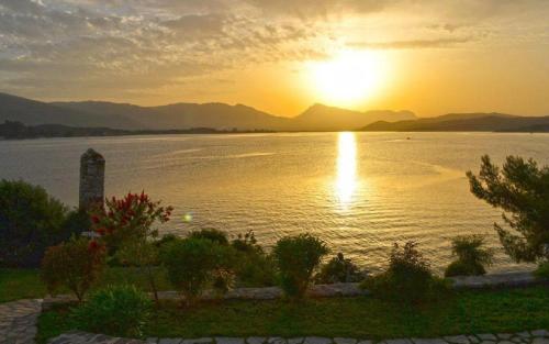 a sunset over a large body of water at Xenia Poros Image Hotel in Poros