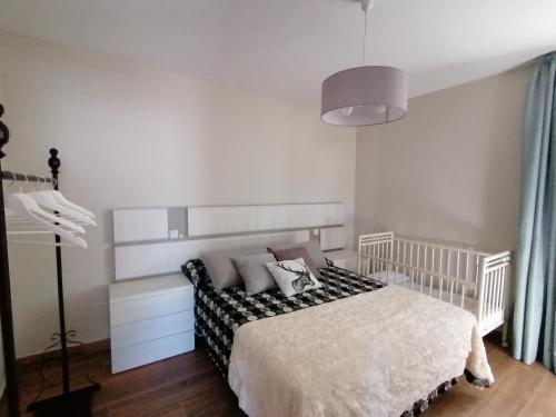 a bedroom with a white bed with pillows at A Casa dos Retales in Cangas de Morrazo