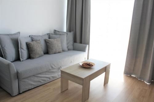 a living room with a couch and a coffee table at Superb seaview apartment in Playa de Las Americas in Playa de las Americas
