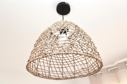 a metal chandelier hanging from a ceiling at Cosy's Olivier in Larmor-Plage