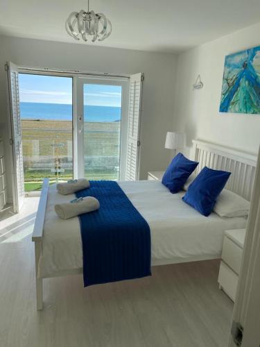 a bedroom with two beds with blue pillows at LUXURY BEACHFRONT OUTSTANDING 2 bedroom APARTMENT in Eastbourne
