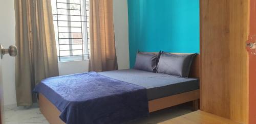 Ένα ή περισσότερα κρεβάτια σε δωμάτιο στο Tranquil Serviced Apartments - HSR Layout