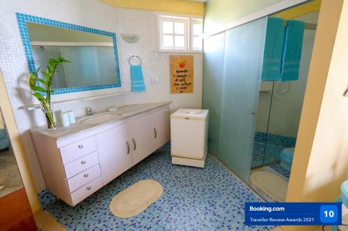 a bathroom with a sink and a shower at Casa a beira mar com 4 suites e muito conforto in Porto De Galinhas