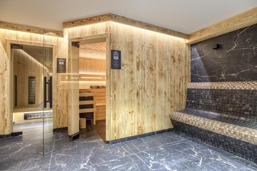 a bathroom with wooden walls and a walk in shower at Willa Litworowy Staw in Bukowina Tatrzańska
