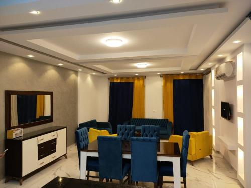 a conference room with a table and chairs and a television at Ramco For Furnished Apartments And Accommodation Compound Leila in Cairo