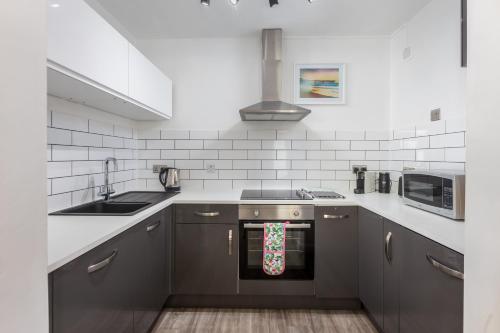 a kitchen with a stove with a christmas ornament on the oven at Westward 14 Polzeath in Polzeath