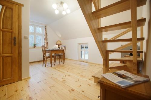 a kitchen and dining room with a spiral staircase in a house at Uspokój Ducha - Adults only in Stara Morawa