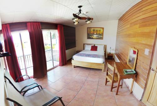 a bedroom with a bed and a table and chairs at Hotel Calle 6 in Bocas Town