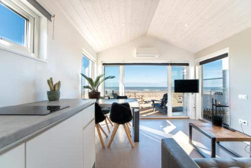 
a living room filled with furniture and a window at BUDDHA BEACH BUNGALOWS Adults Only in Zandvoort
